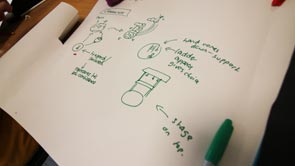 A sheet of white paper with green pen marks on it to depict the storyboard of an animation